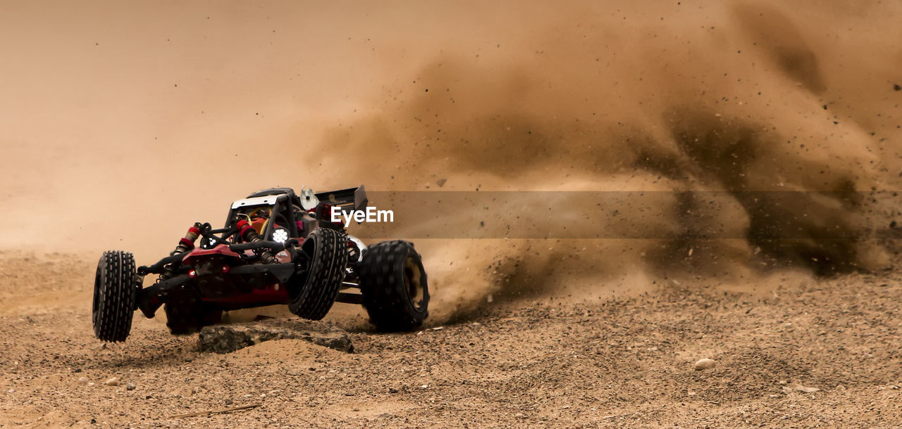 Off-road vehicle during race on dirt field