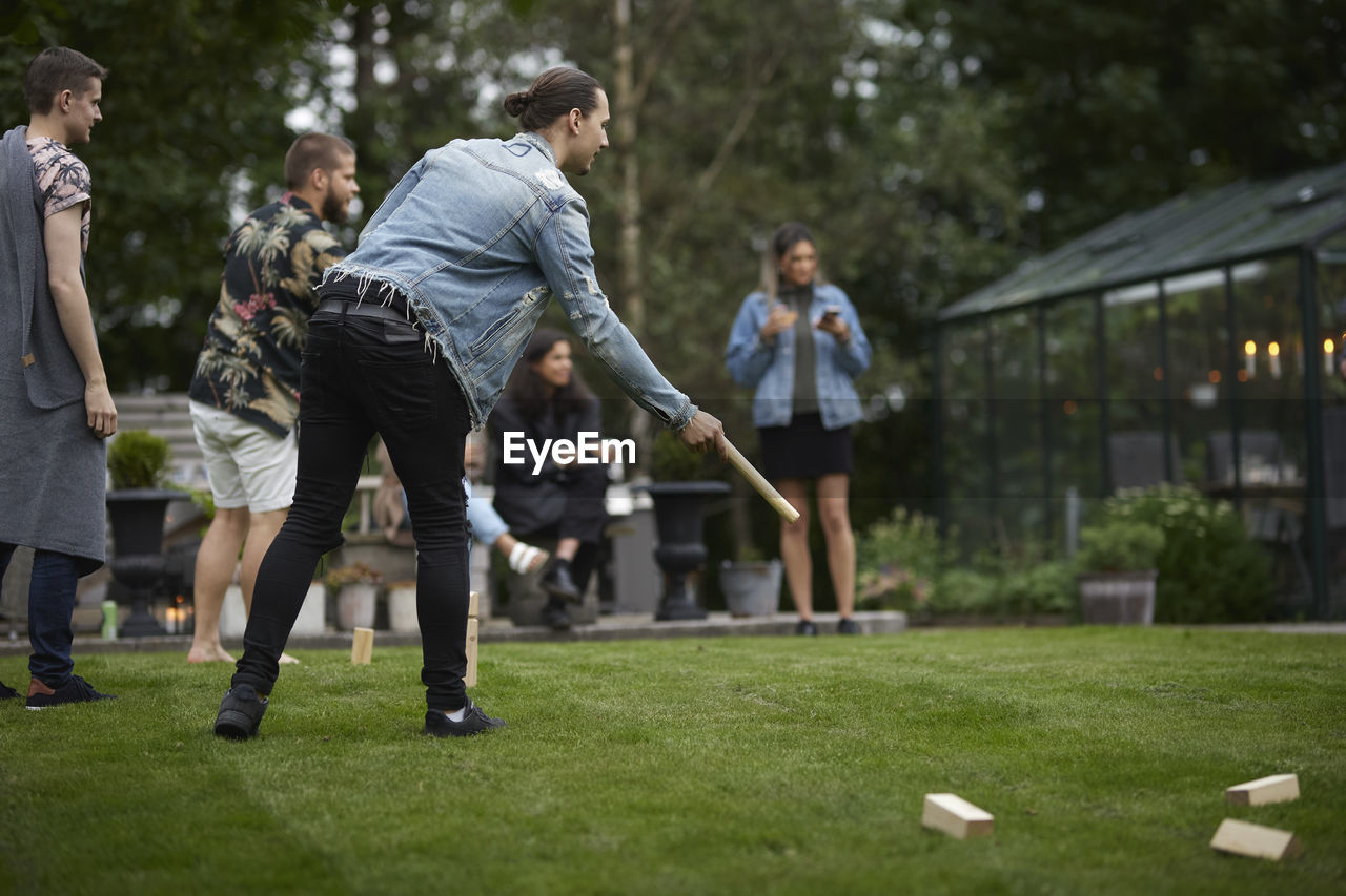 Friends playing molkky in garden