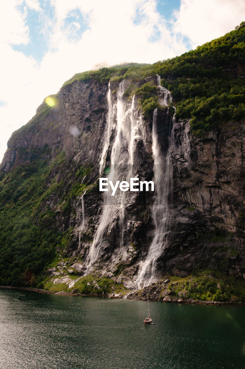 Scenic view of waterfall in geiranger fjørd