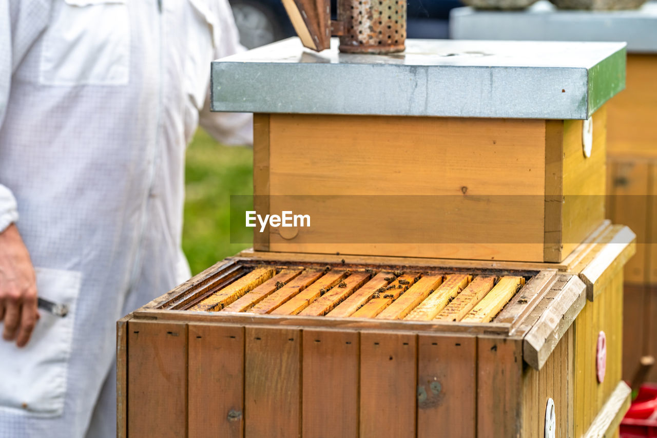 CLOSE-UP OF MAN STANDING IN CRATE