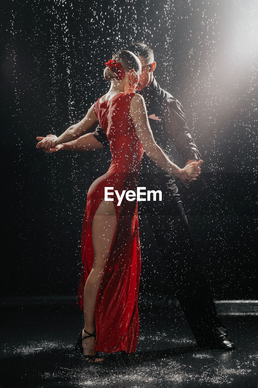 A couple of dancers on a black background in a studio in the aqua zone