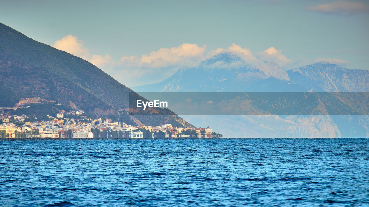 Scenic view of sea and buildings against sky