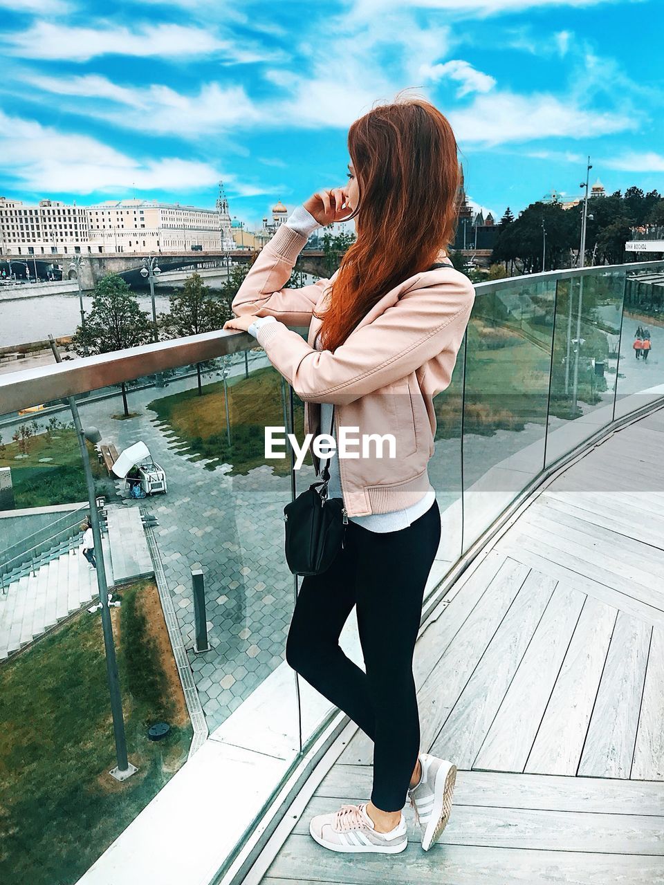 FULL LENGTH OF YOUNG WOMAN STANDING AT SHORE