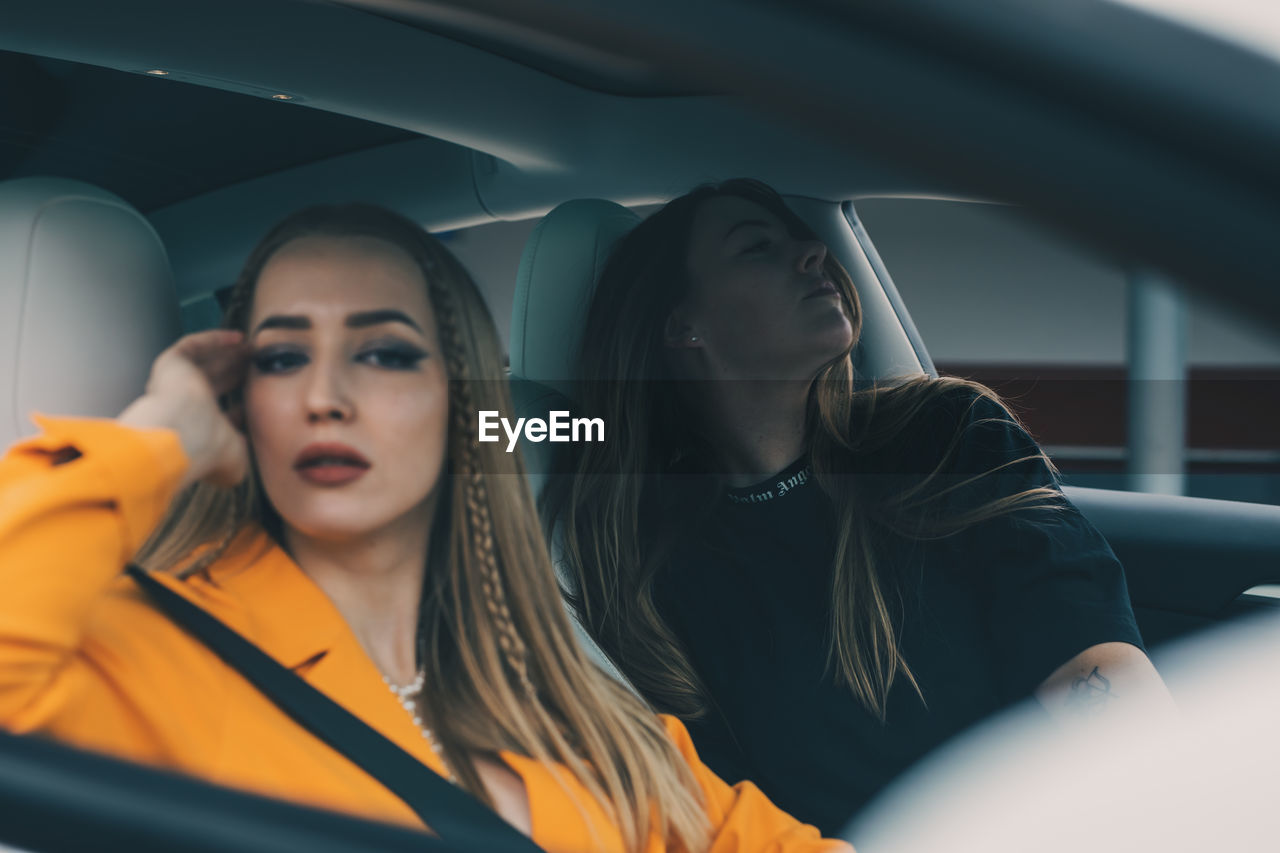 Young woman sitting in car