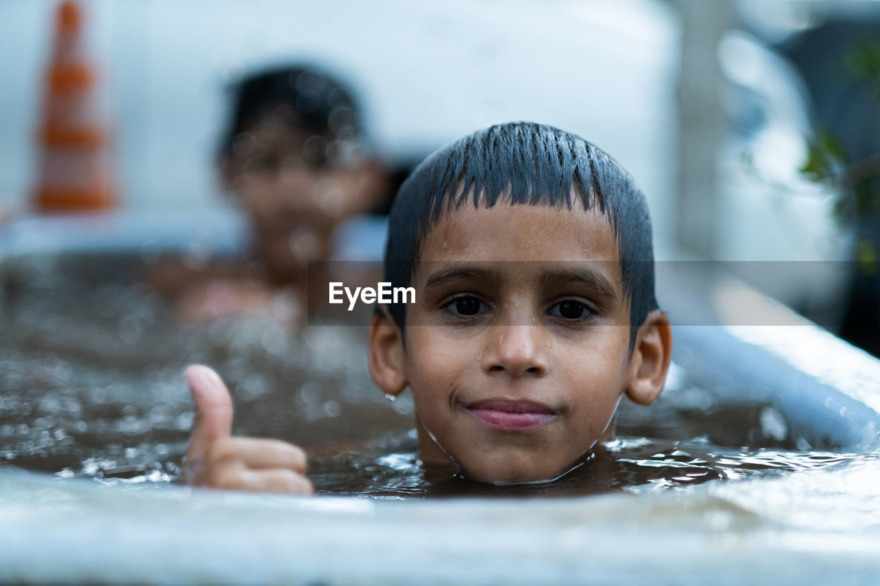 portrait of young man swimming in sea