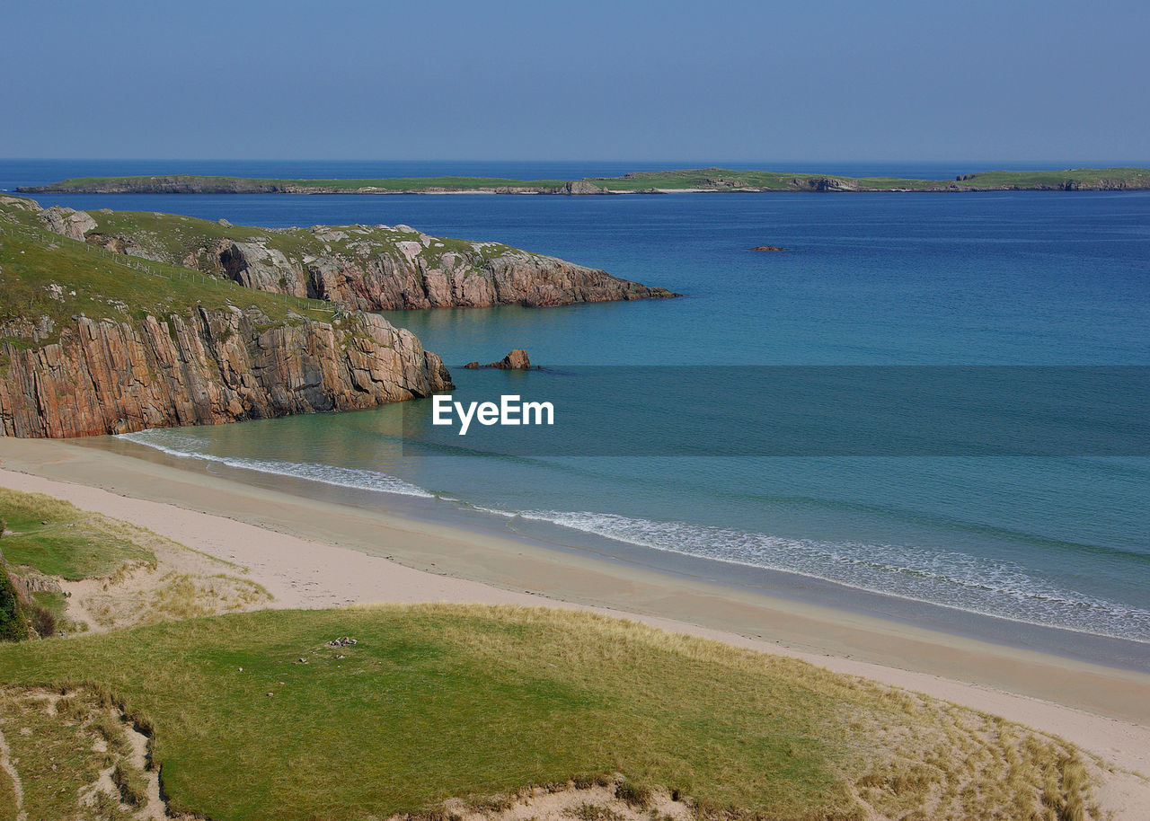 Scenic view of sea against clear blue sky