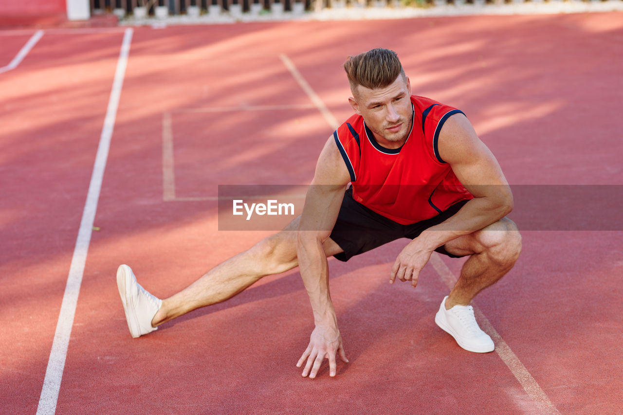 side view of man exercising in gym