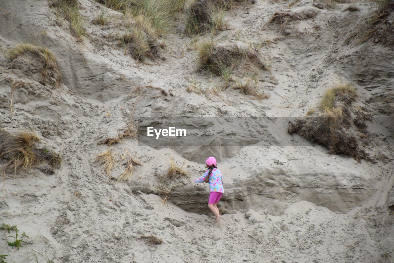 Rear view of girl climbing on mountain