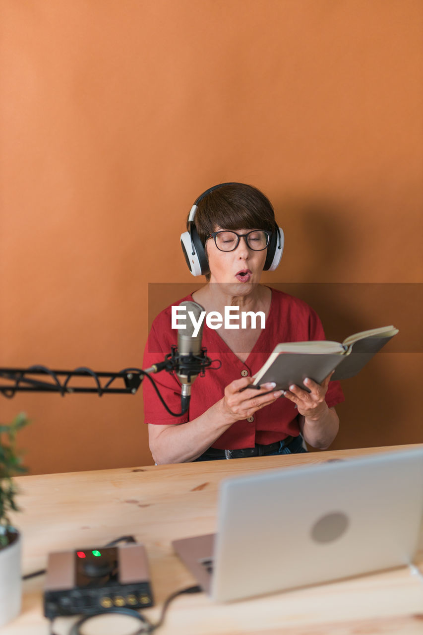 Woman podcasting at studio