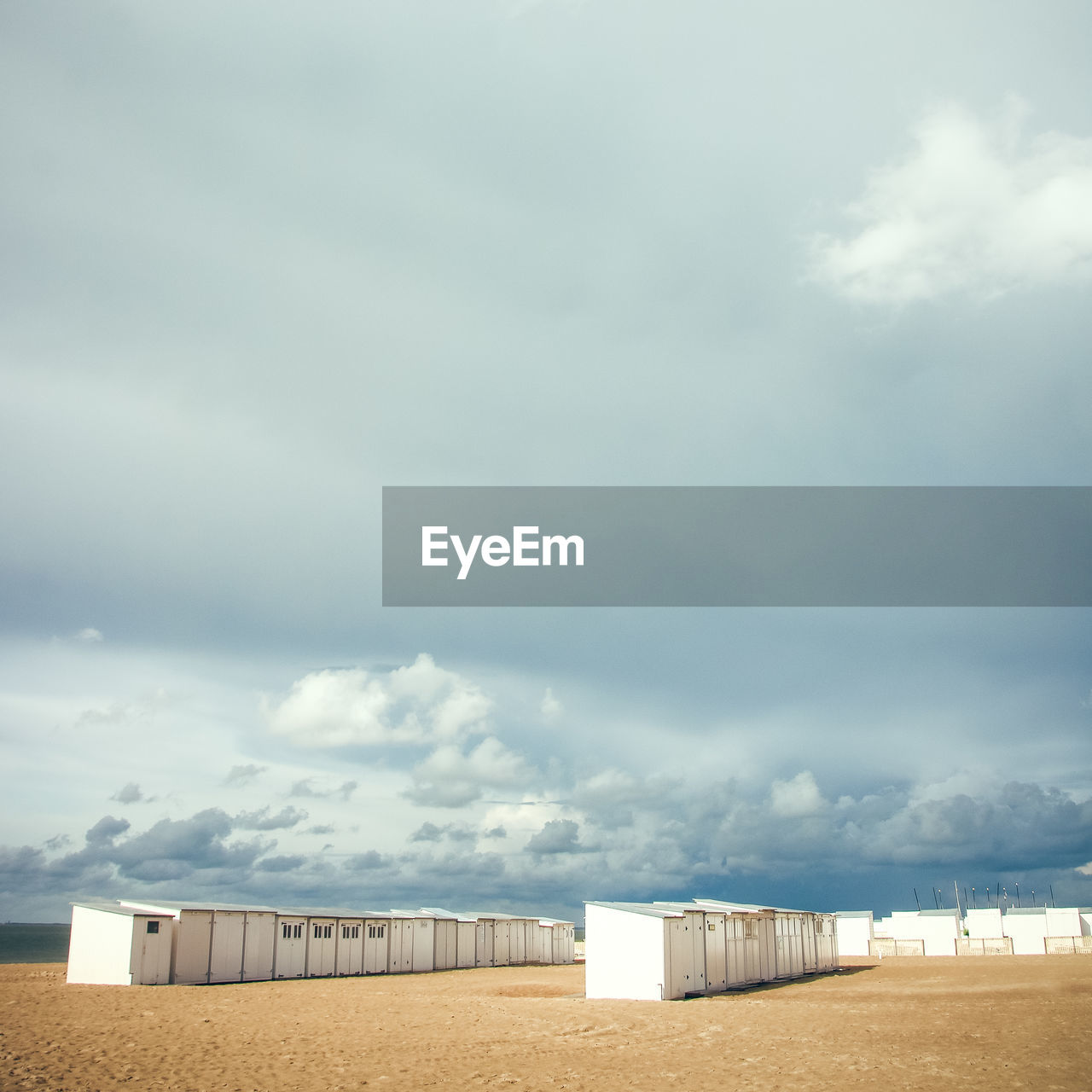 Scenic view of beach huts against sky