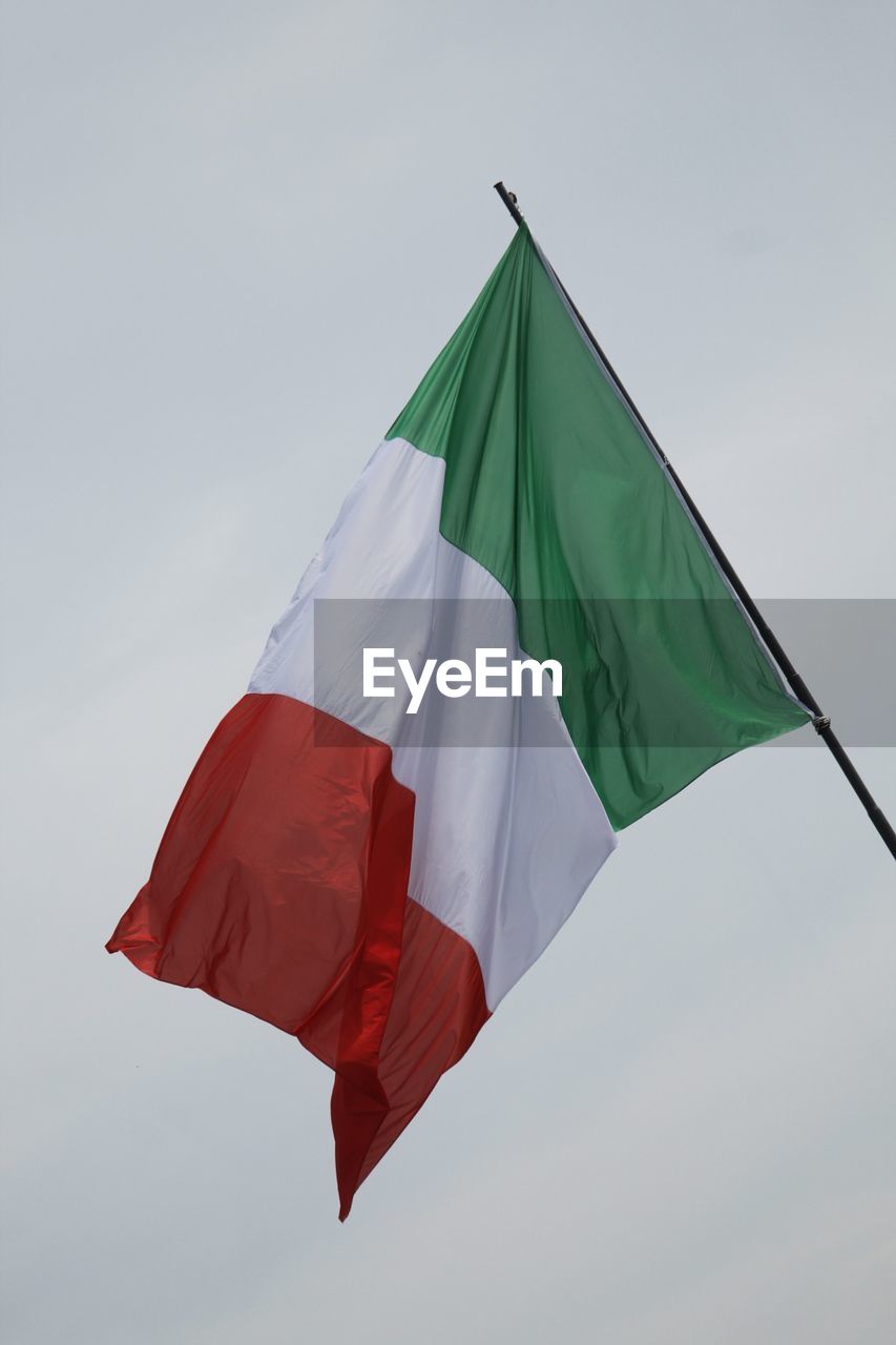 Low angle view of italian flags against clear sky