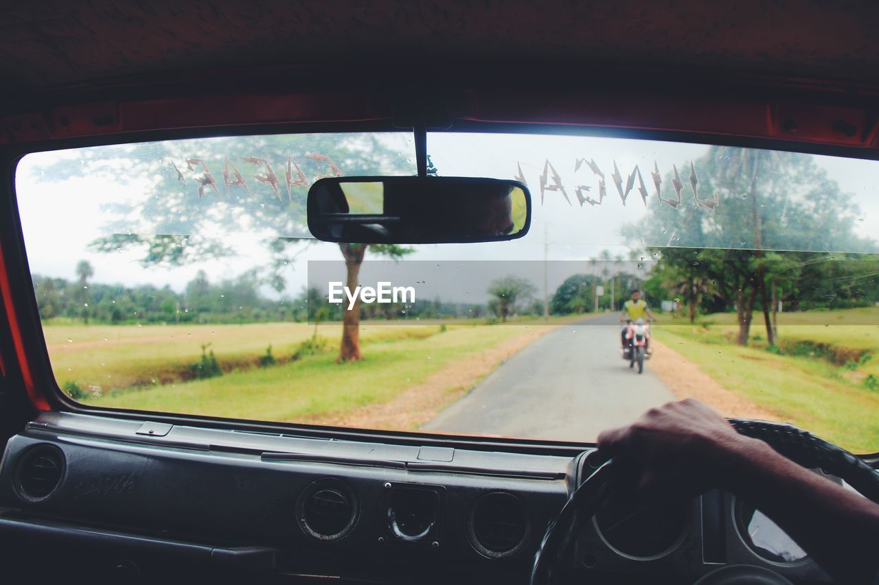 CAR ON ROAD SEEN THROUGH WINDSHIELD