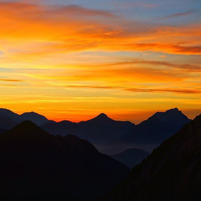 SCENIC VIEW OF MOUNTAINS AT SUNSET