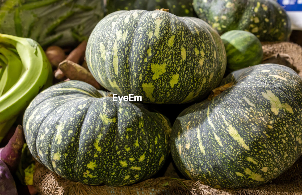 food and drink, food, healthy eating, freshness, wellbeing, vegetable, plant, market, produce, winter squash, no people, gourd, organic, fruit, retail, melon, close-up, market stall, abundance, still life, green, large group of objects, pumpkin, for sale, watermelon, raw food, squash, squash - vegetable, outdoors, nature, agriculture, day