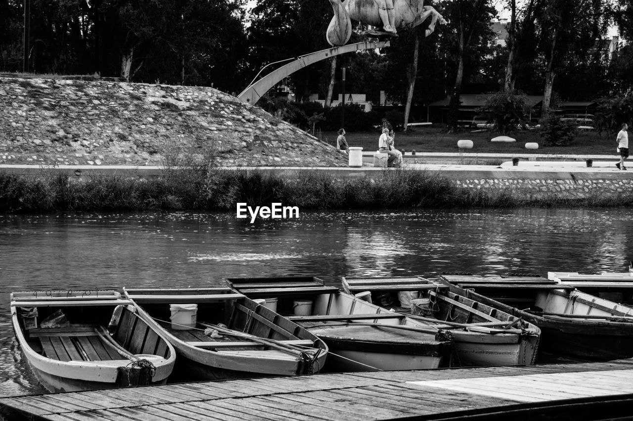 BOATS MOORED ON LAKE
