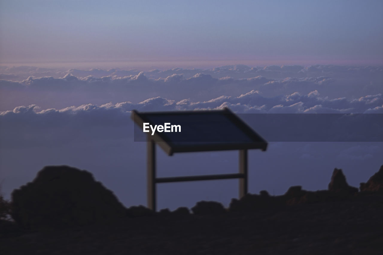 Low angle view of silhouette mountain against sky at sunset