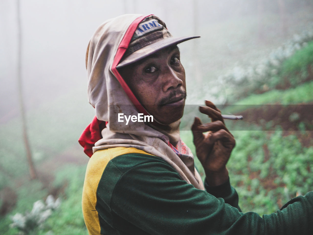 MID ADULT MAN SMOKING ON CIGARETTE