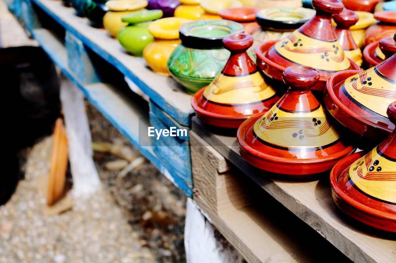 High angle view of multi colored containers in row on table