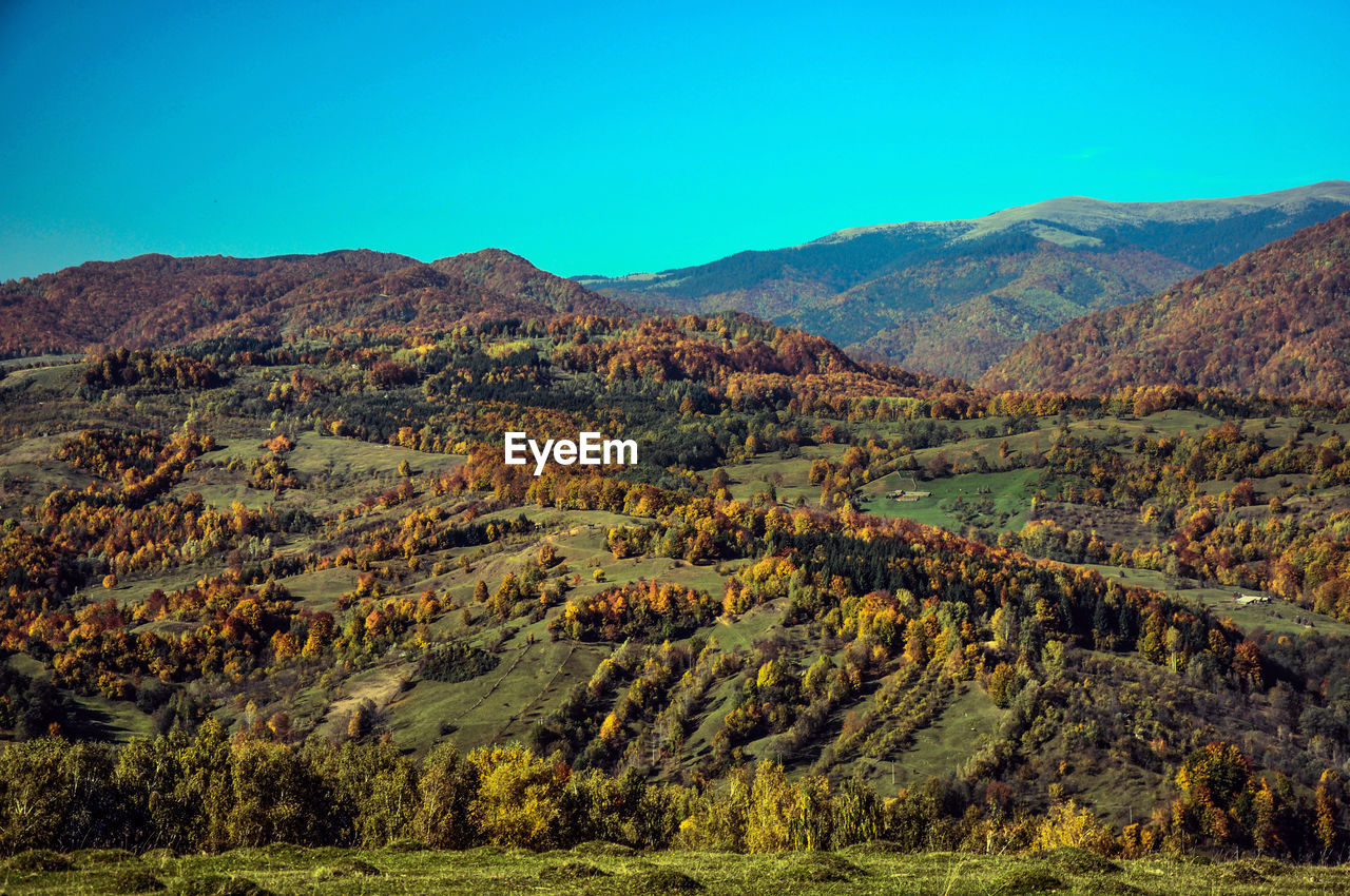 SCENIC VIEW OF MOUNTAINS AGAINST CLEAR SKY