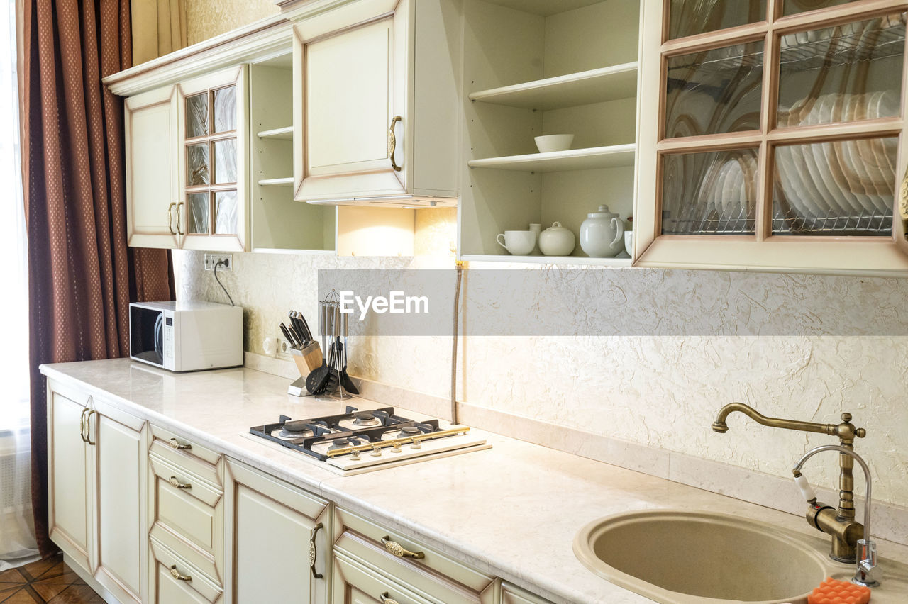 White kitchen set in house with a large dining room.