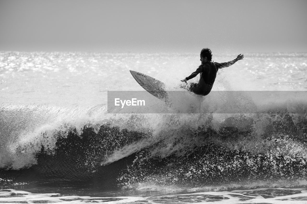 MAN SURFING IN SEA