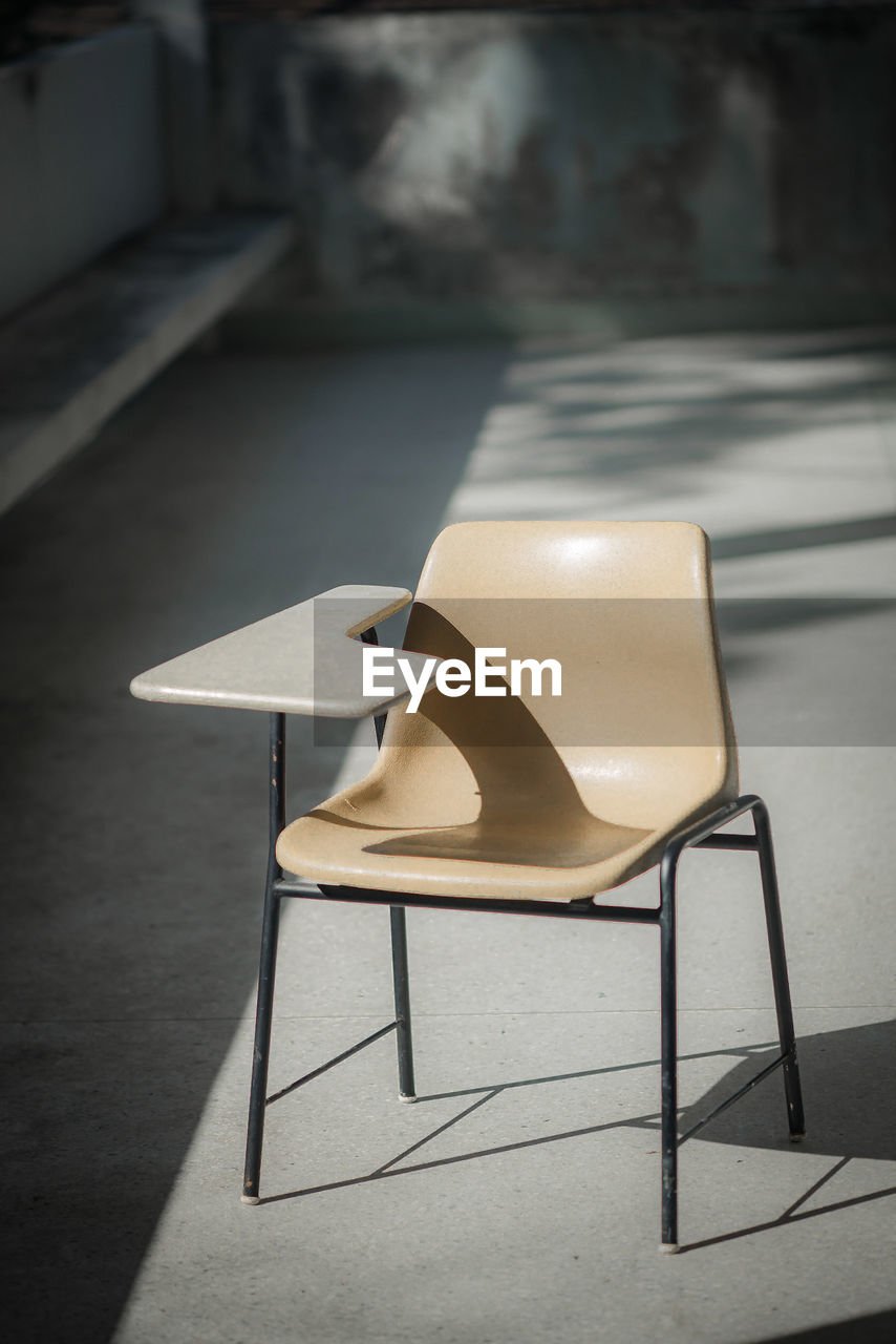 High angle view of empty chair on table