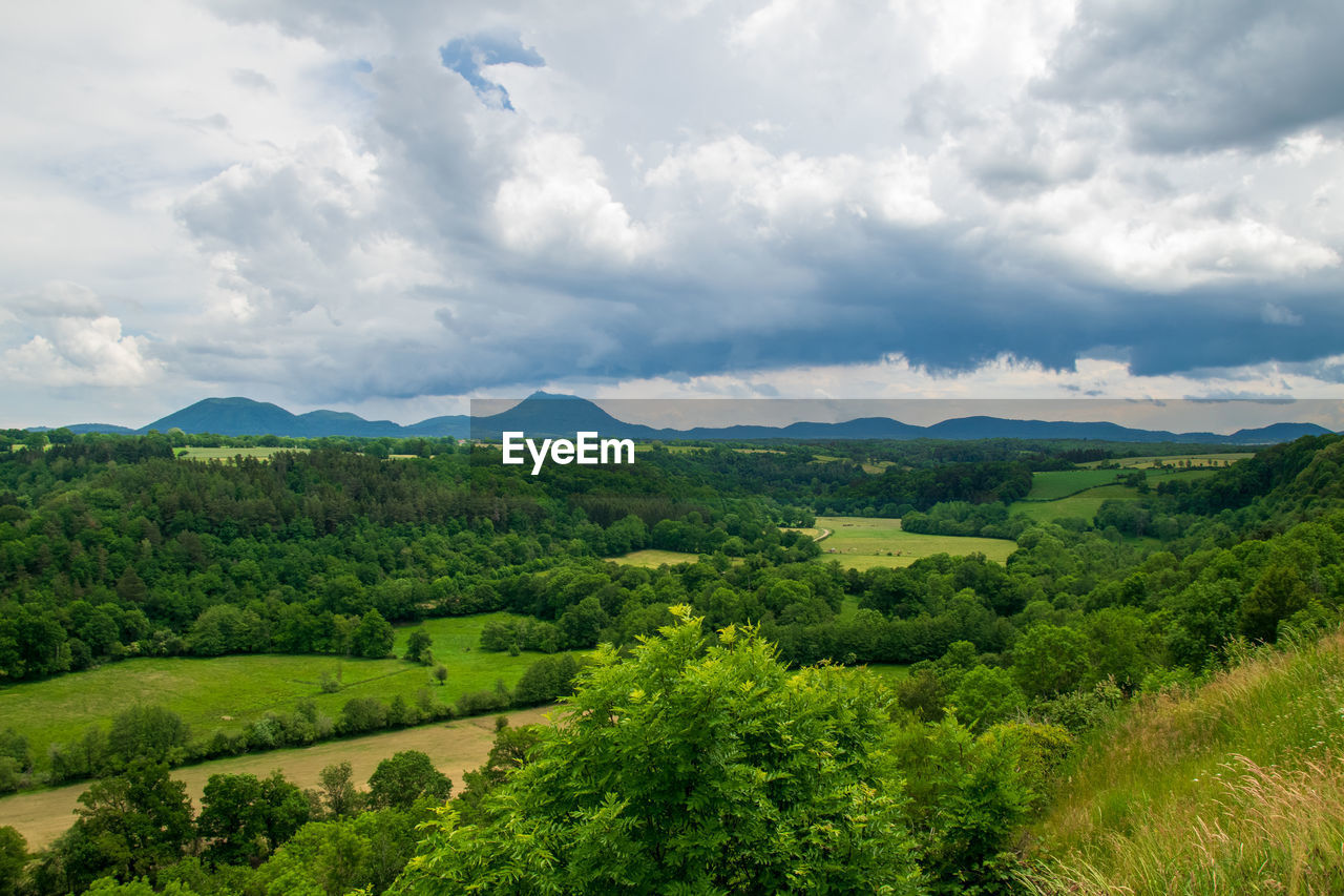 View of the chain of auvergne volcanoes under a thunderstorm