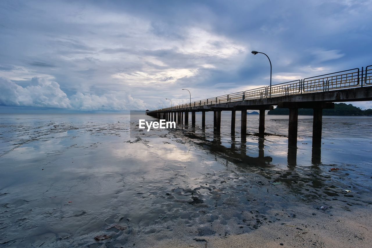 Pier over sea against sky