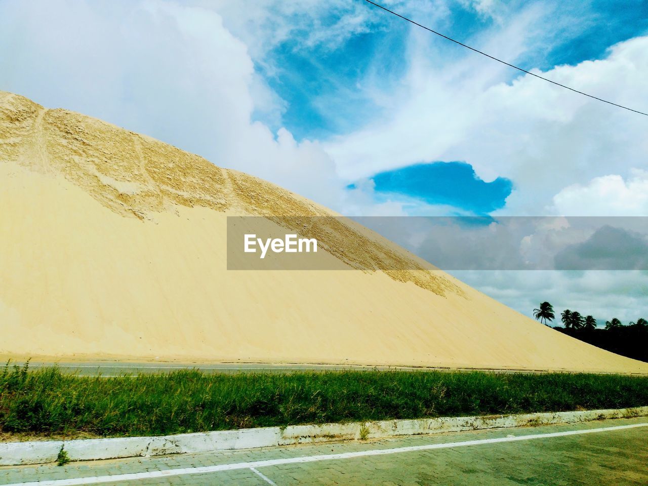 PANORAMIC VIEW OF ROAD BY LAND AGAINST SKY