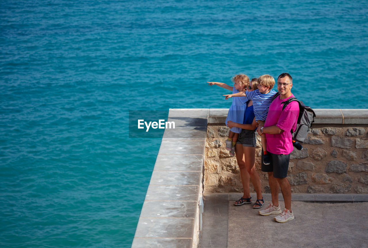 rear view of woman walking on pier