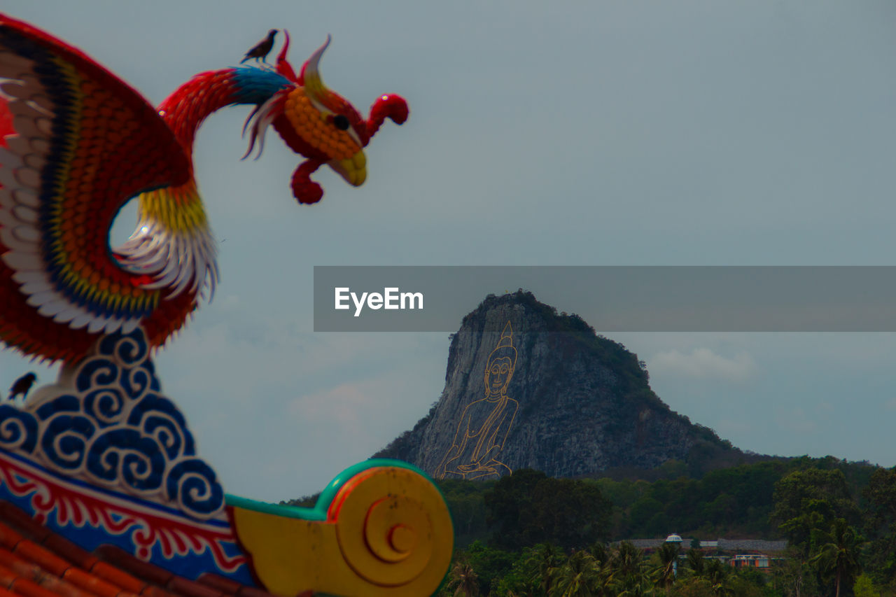 LOW ANGLE VIEW OF STATUE ON MOUNTAIN