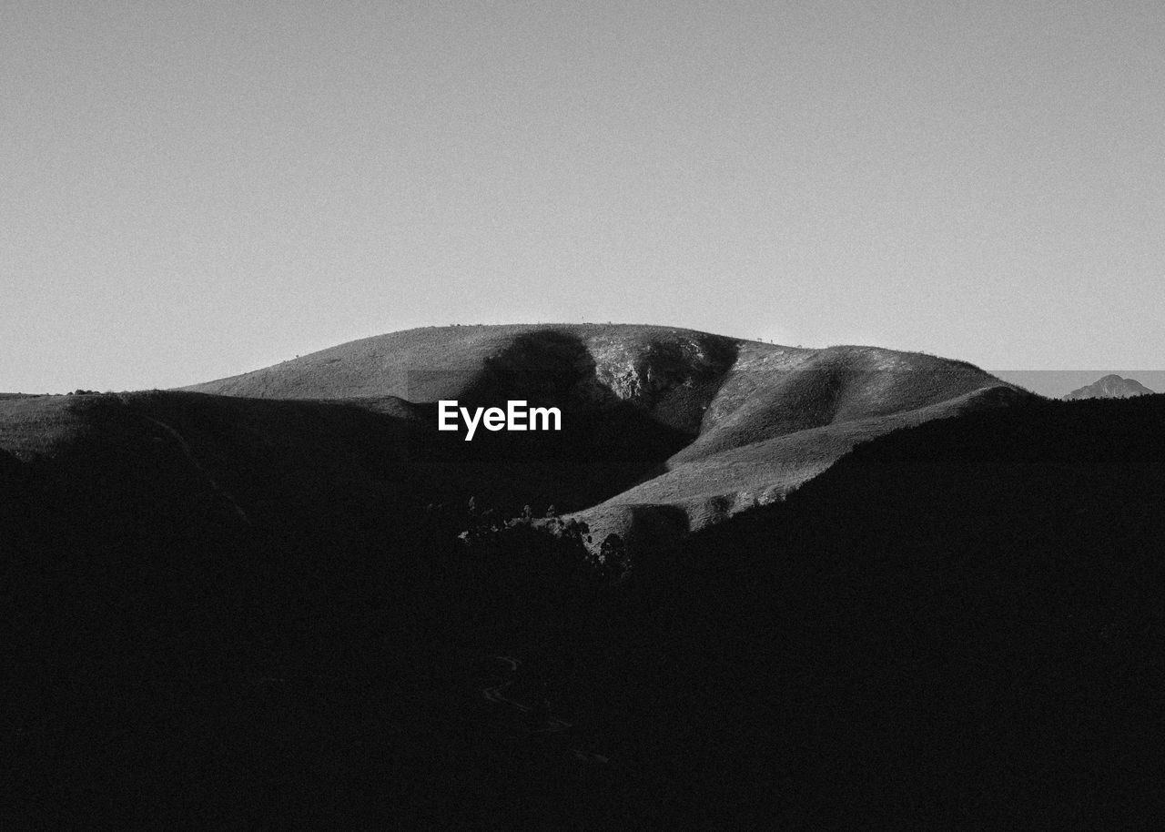 LOW ANGLE VIEW OF MOUNTAINS AGAINST CLEAR SKY