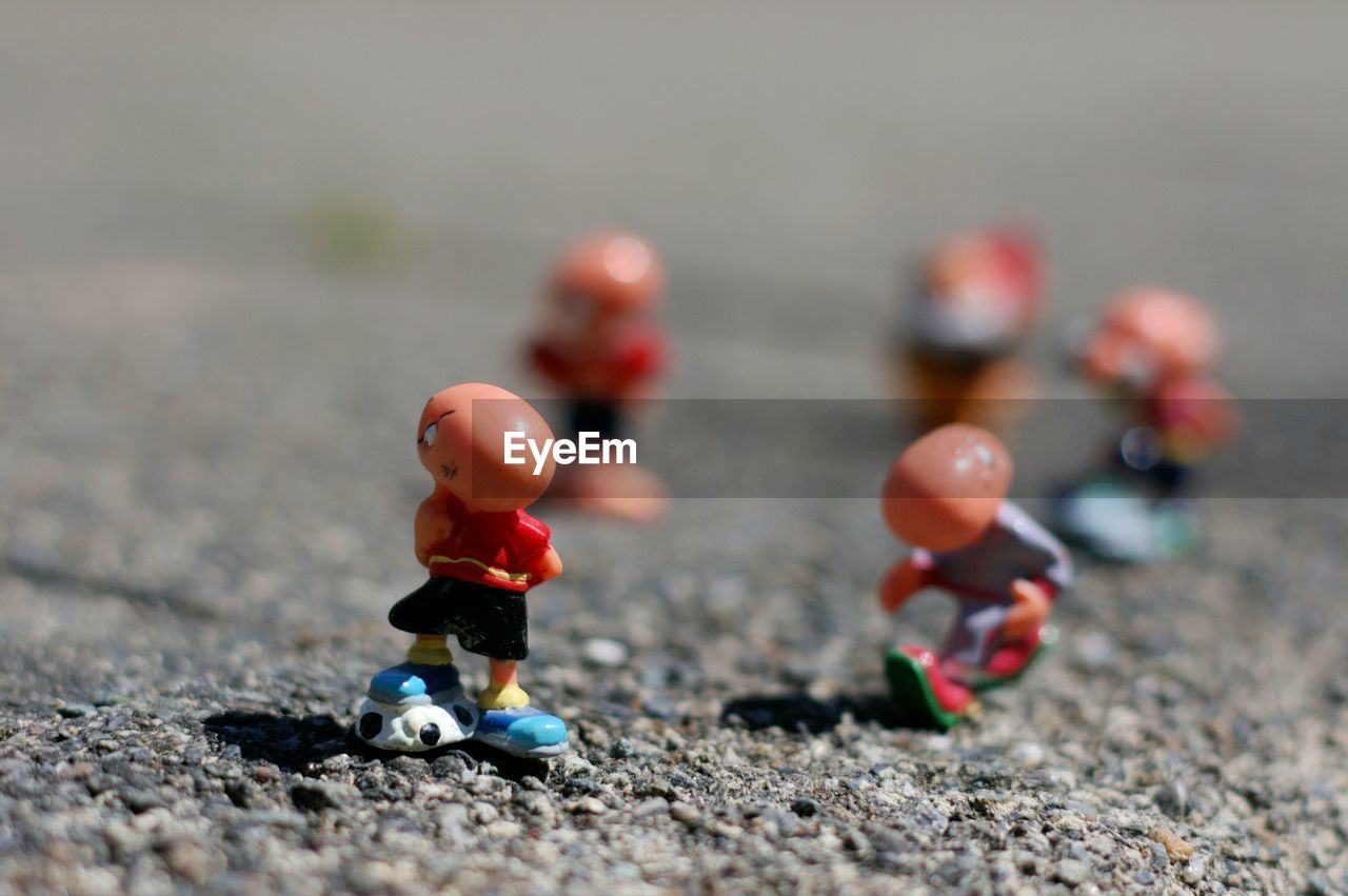 CLOSE-UP OF FIGURINE WITH TOY ON TABLE