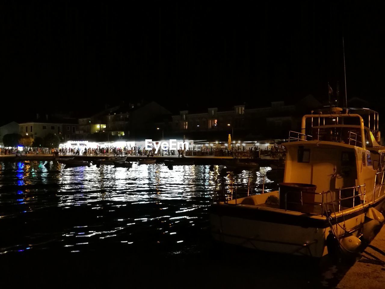 BOATS MOORED AT HARBOR AGAINST SKY AT NIGHT