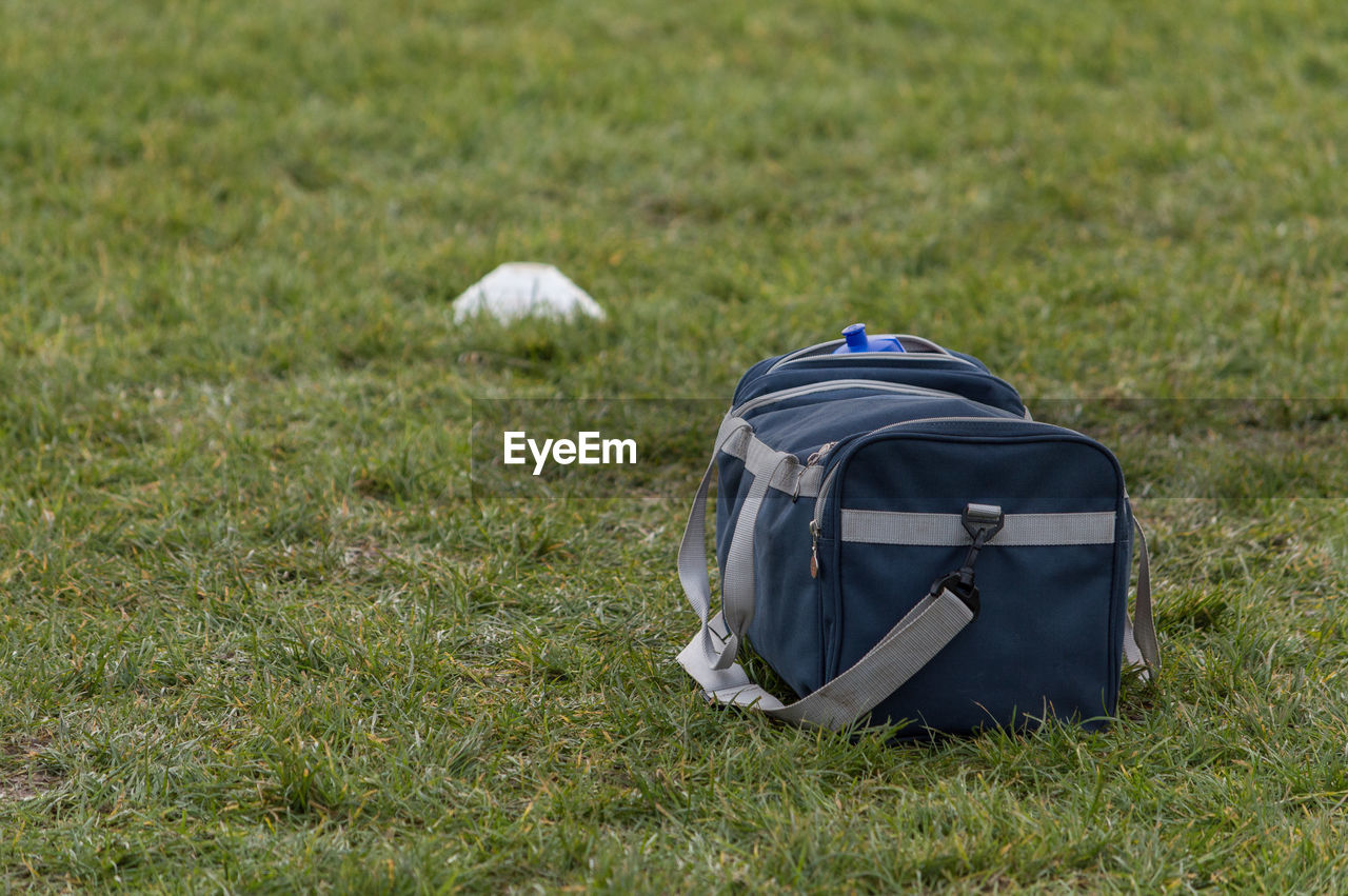 Close-up of bag on grassy field