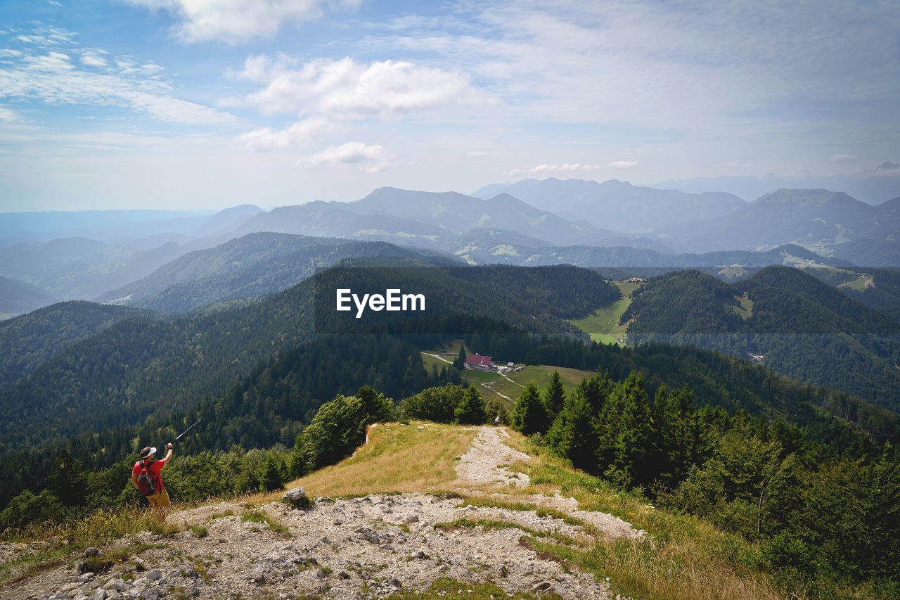 Scenic view of man hiking in mountains