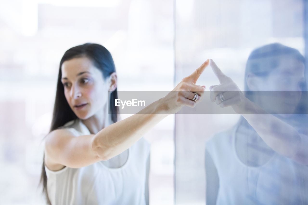 Businesswoman giving presentation in meeting at conference room