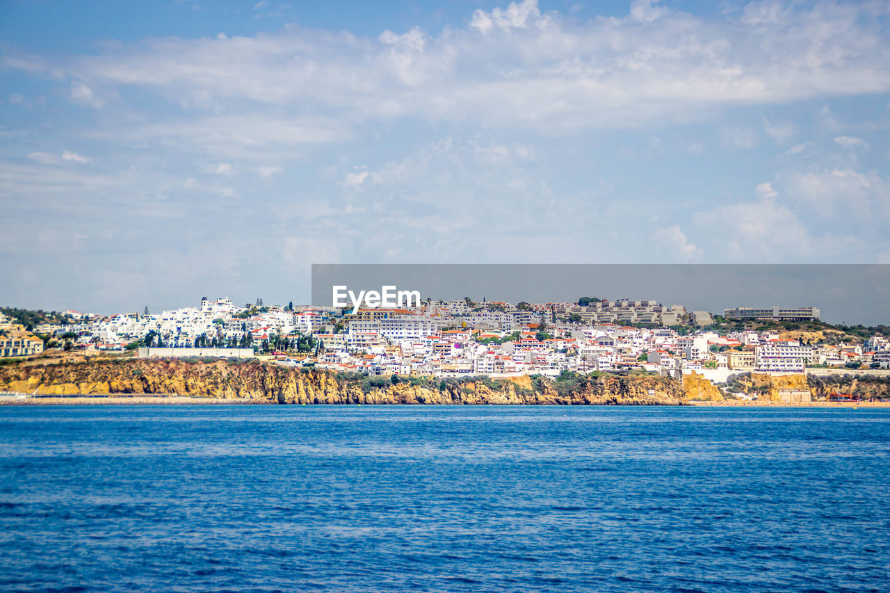 Scenic view of sea and buildings against sky