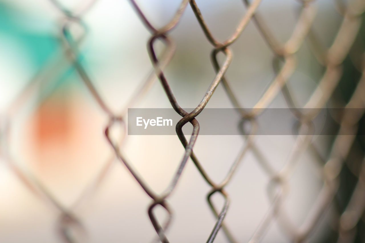 Close-up of chainlink fence against sky