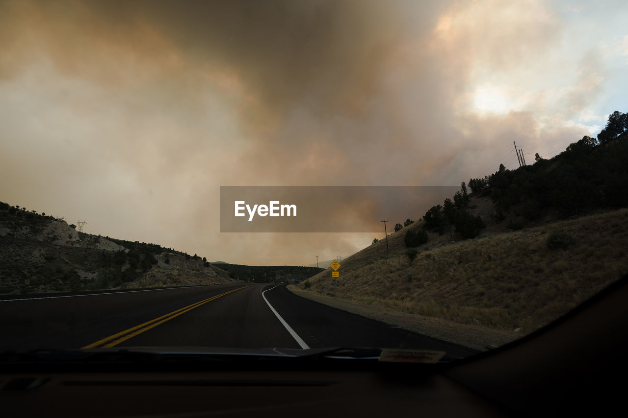 Road against sky seen through car windshield