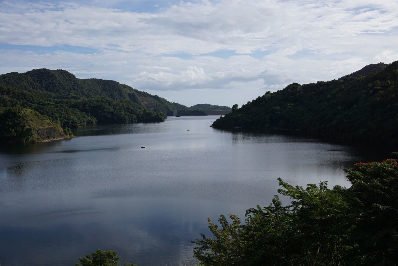 Scenic view of mountains and river against sky