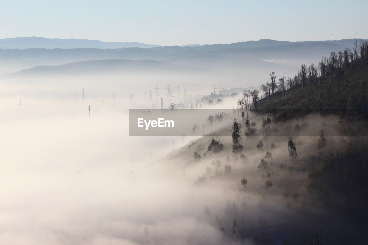 Misty landscape against clear sky