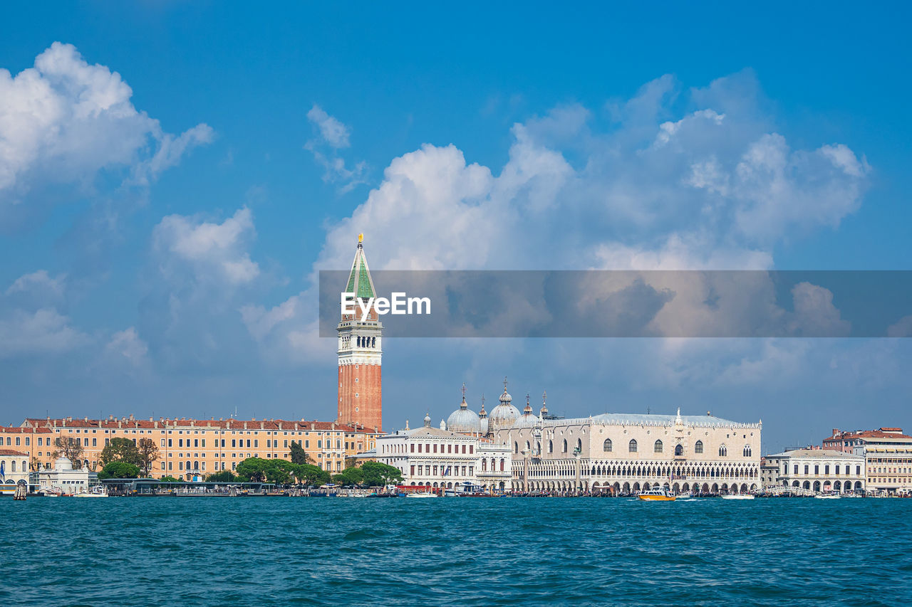 VIEW OF BUILDING BY SEA AGAINST SKY