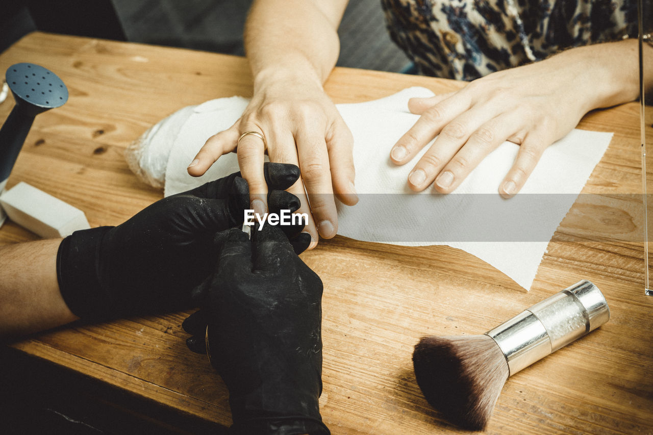 Beautician working with mask and protective screen for the virus covid