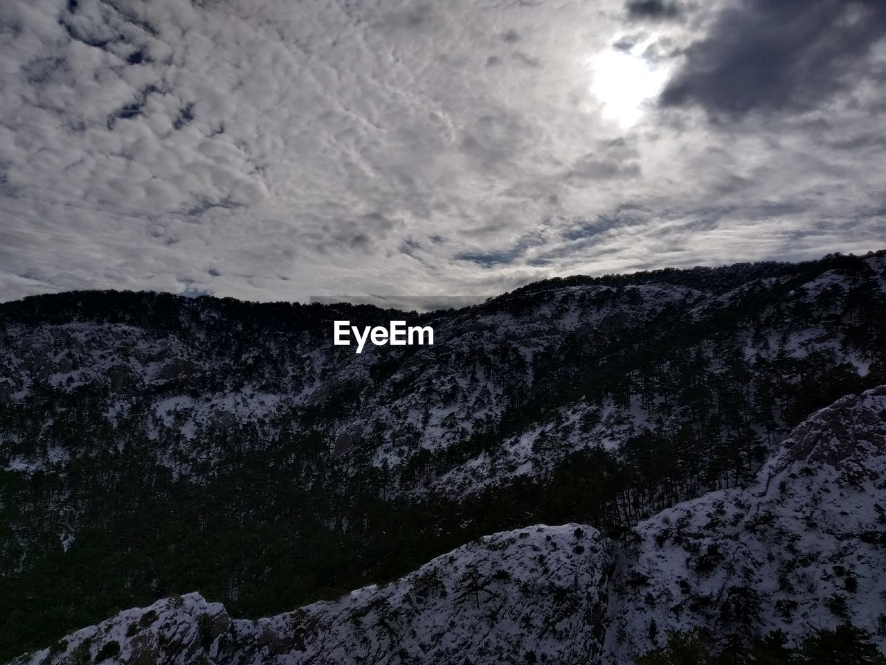 Low angle view of snowcapped mountain against sky