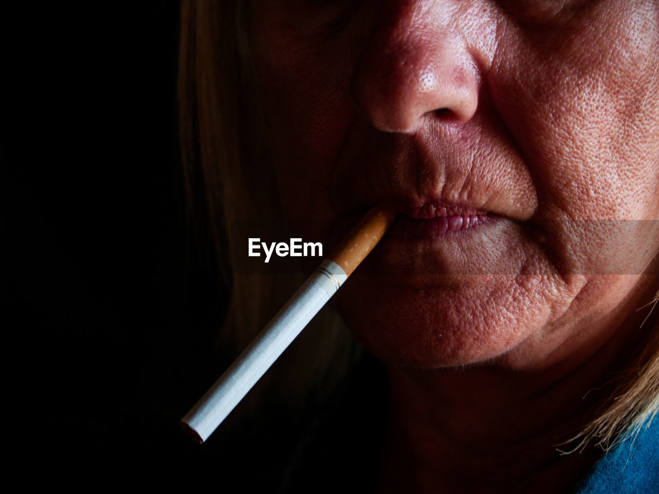 Close-up of mature woman smoking cigarette