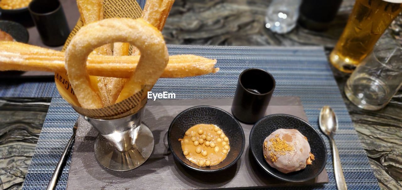 food and drink, food, fast food, snack, meal, dish, no people, freshness, pretzel, drink, fried, baked, table, indoors, breakfast, refreshment, sweet food, kitchen utensil, household equipment, produce, high angle view, onion ring, unhealthy eating