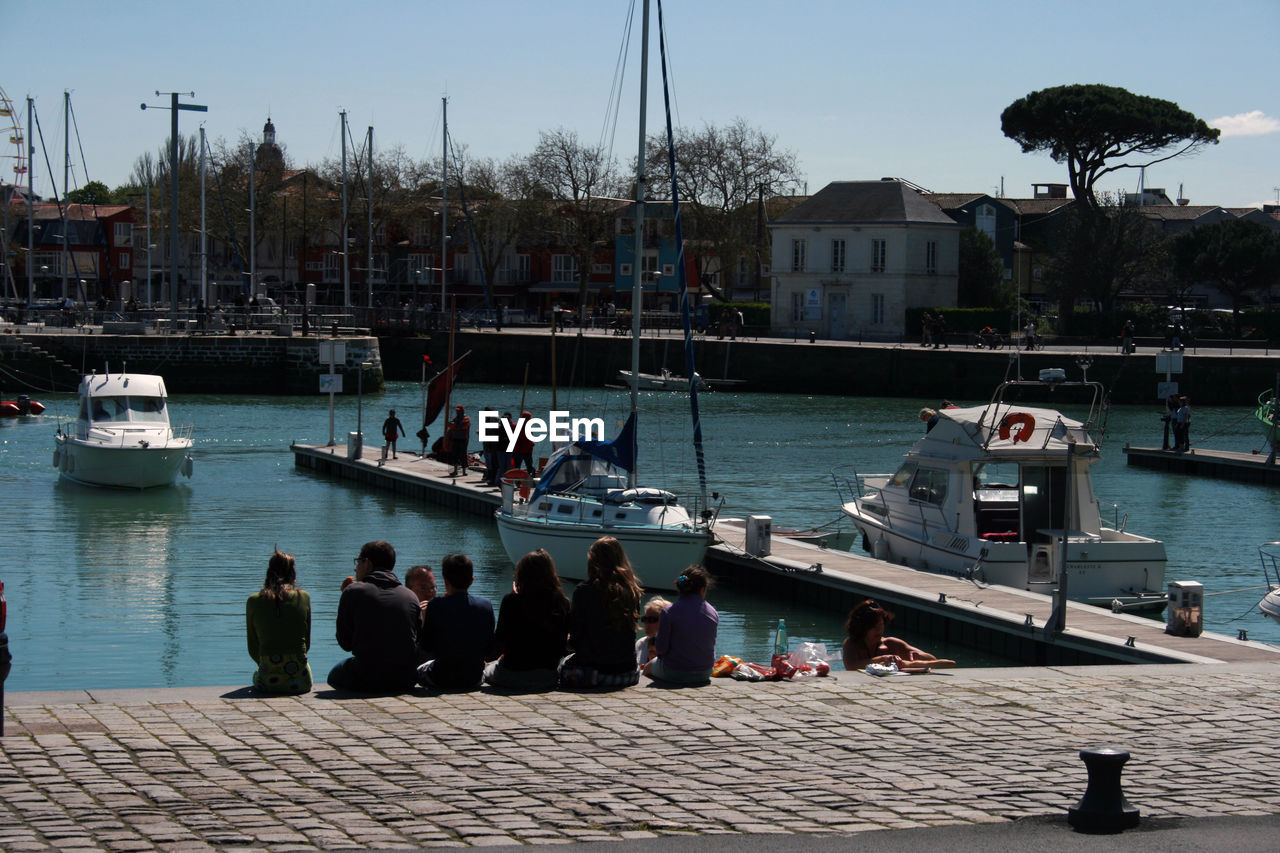 PEOPLE ON BOATS IN RIVER