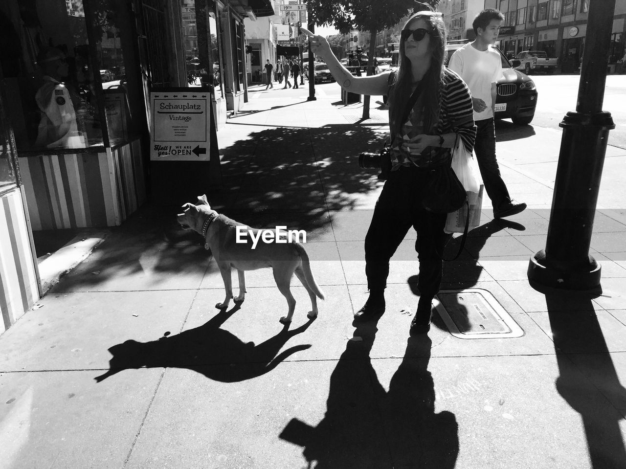 WOMAN STANDING ON CITY STREET