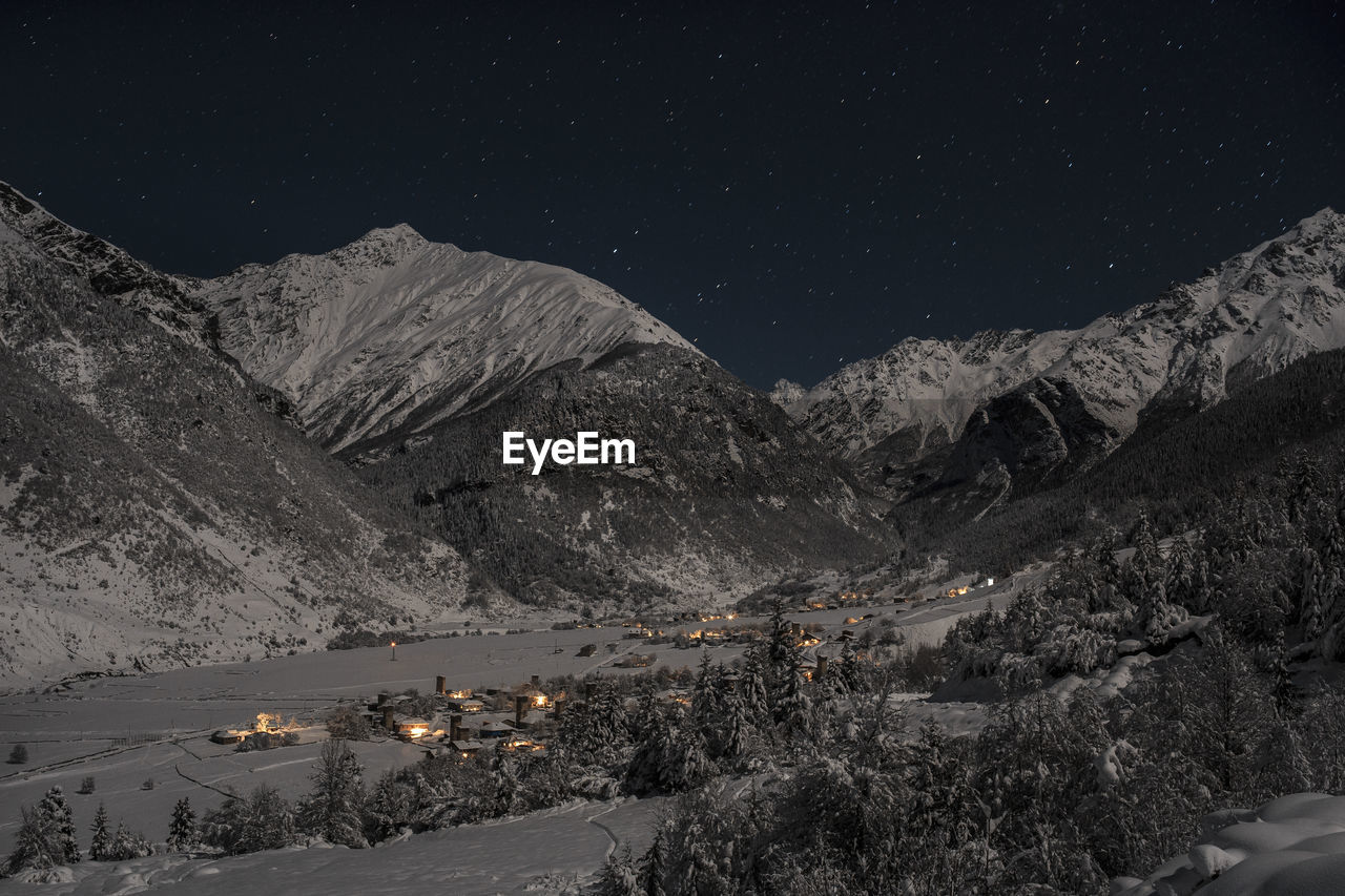 Scenic view of mountains against sky at night